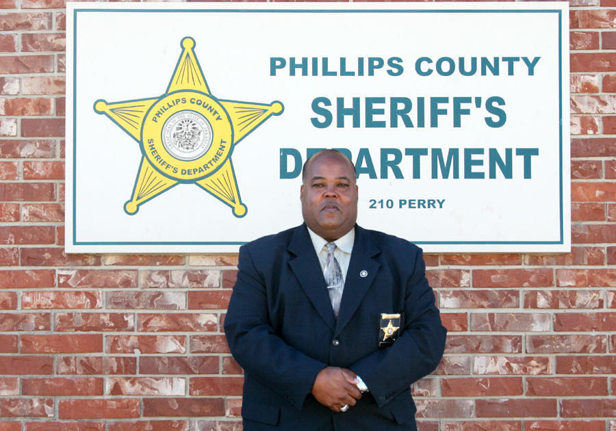 Chief Deputy Darrell Winston standing in front of Phillips County Sheriff's Office sign